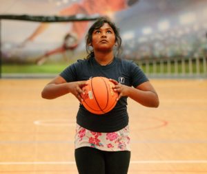 A young person about to shoot a basketball