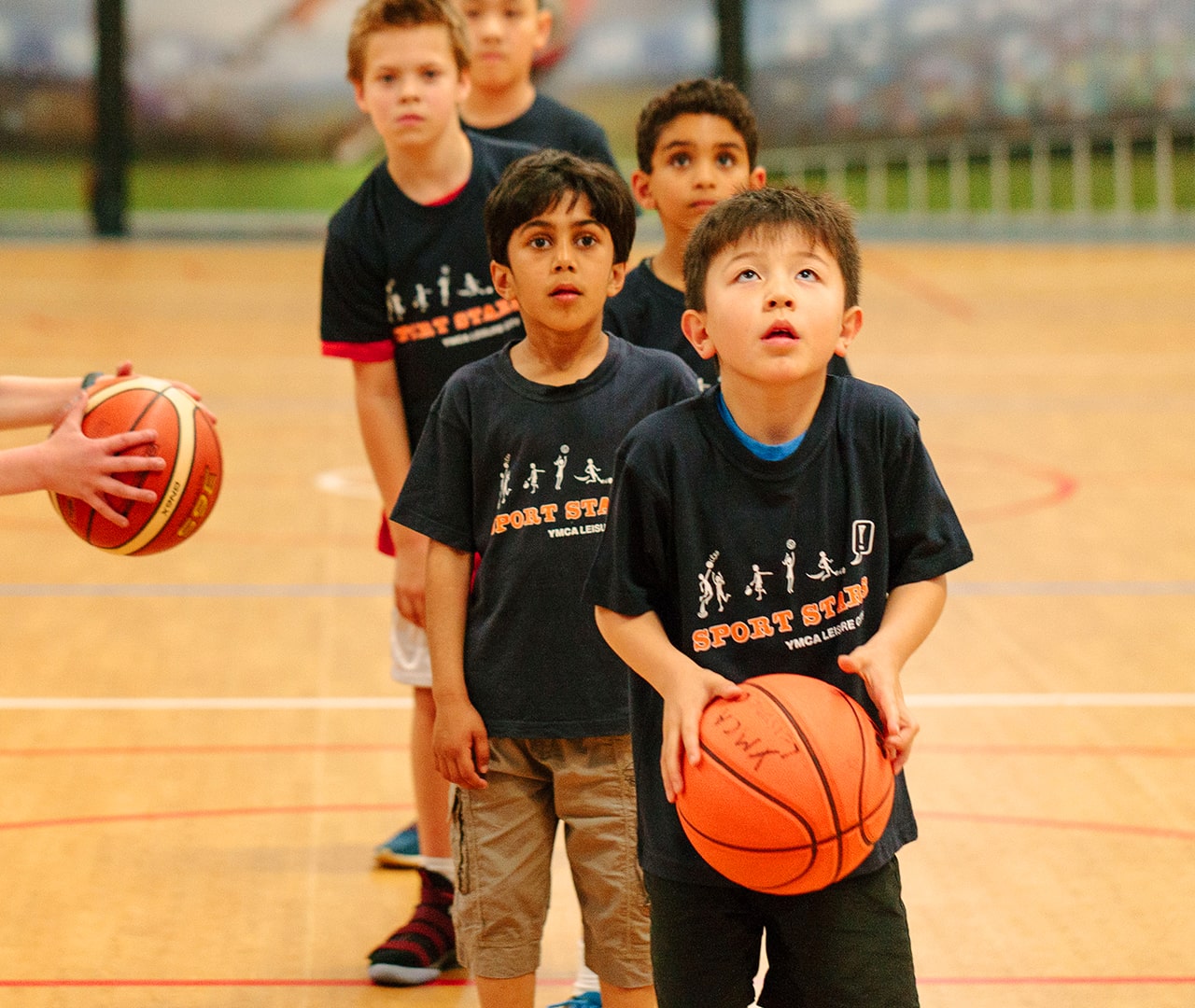 Young children focussed on basketball training