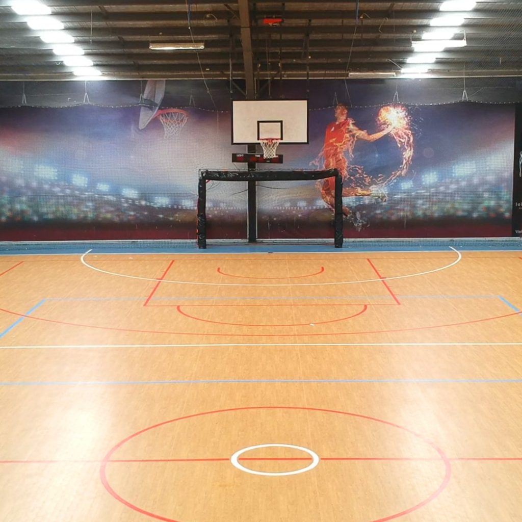 A photo of the multi-purpose court with a soccer goal and basketball net